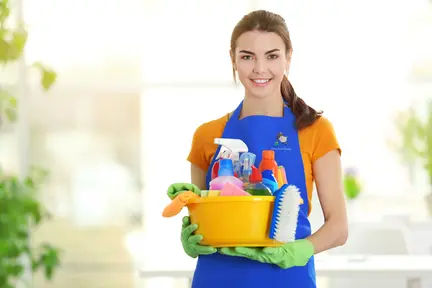 Person holding a caddy of cleaning equipment