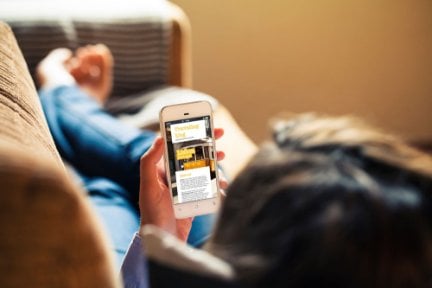 Person booking on phone on their sofa