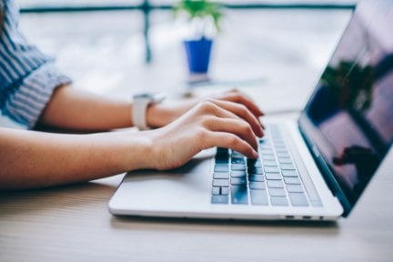 Person typing on laptop