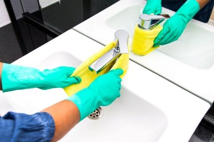 Person cleaning a tap