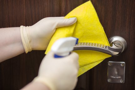 A person cleaning a door handle